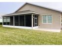 Enclosed screened porch, perfect for outdoor dining and entertaining, with backyard views at 436 Eldora Dr, Oak Hill, FL 32759