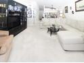 Bright living room featuring a white leather sectional sofa and a large entertainment center at 445 Bouchelle Dr # 301, New Smyrna Beach, FL 32169