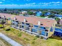Aerial view of condo complex with private balconies, parking and lush landscaping in a beach community at 4752 S Atlantic Ave # 1, Ponce Inlet, FL 32127