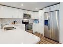 Bright kitchen featuring white cabinetry, stainless steel appliances, and a stylish backsplash at 4752 S Atlantic Ave # 1, Ponce Inlet, FL 32127