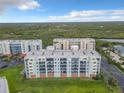 An aerial view of a condo community with lovely landscaping and surrounding marsh land at 5300 S Atlantic Ave # 3-405, New Smyrna Beach, FL 32169
