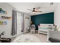 Cozy bedroom with neutral decor, featuring a ceiling fan and ample natural light at 5304 Cordgrass Bend Ln, Port Orange, FL 32128