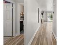 Bright hallway featuring wood floors, leading to bedrooms and the living area at 5304 Cordgrass Bend Ln, Port Orange, FL 32128