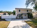 Two-story home featuring a long driveway, fenced yard, and well-kept landscaping at 653 Sweetwood Dr, Port Orange, FL 32127