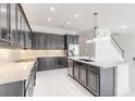 Modern kitchen features granite countertops, stainless steel appliances, and stylish cabinetry at 6808 Forkmead Ln, Port Orange, FL 32128