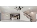 An open-concept living space boasts a modern kitchen and access to the staircase at 6808 Forkmead Ln, Port Orange, FL 32128