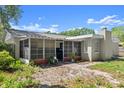 Back exterior view of home featuring a screened enclosure and mature landscaping at 126 Brandy Hills Dr, Port Orange, FL 32129