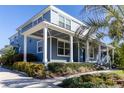 Beautiful two-story home featuring a spacious covered porch with stylish columns and lush landscaping at 1787 Earhart Ct, Port Orange, FL 32128