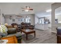Inviting living room featuring vaulted ceiling, ceiling fan, and an open layout into the kitchen at 2204 Kumquat Dr, Edgewater, FL 32141