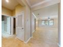 Open-concept living space with tile flooring, neutral walls, and ample natural light from large windows at 3455 Pegaso Ave, New Smyrna Beach, FL 32168