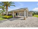 Charming single-story home featuring a covered entrance with stately columns and a brick paver driveway at 4177 Mayfair Ln, Port Orange, FL 32129