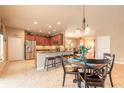Open-concept kitchen featuring granite countertops, stainless appliances, a breakfast bar, and a dining area at 6950 Vintage Ln, Port Orange, FL 32128