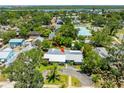 Charming home featuring mature trees, a metal roof, and a circular driveway near the bay at 913 Palmetto St, New Smyrna Beach, FL 32168
