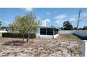 Image shows the home's backyard with partial views of the screened in porch at 1077 Willow Wood Dr, Port Orange, FL 32129
