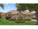 Beautiful one-story home featuring mature landscaping, a barrel tile roof, and neutral stucco siding at 11222 Rapallo Ln, Windermere, FL 34786