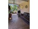 Relaxing screened patio with a comfortable couch and potted plants, great for enjoying the outdoors in comfort at 115 Los Arbor Dr, Deland, FL 32724