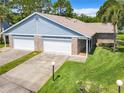 Charming exterior showcasing a two-car garage and well-maintained lawn at 116 Duck Hawk Cir # 3040, Daytona Beach, FL 32119