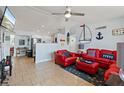 Cozy living room with tiled floors, a ceiling fan, and nautical-themed décor at 13 Essex Dr, Ormond Beach, FL 32176