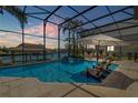 Stunning screened-in pool area with outdoor seating and beautiful views of the canal at 133 Via Capri, New Smyrna Beach, FL 32169