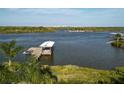 Waterfront view features a dock, boat cover and tranquil water views with city skyline at 1601 S Riverside Dr, Edgewater, FL 32132