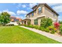 Well-maintained home exterior with lush landscaping and a beautiful lawn and walkway at 1703 Frogs Leap Ct, Port Orange, FL 32128