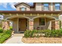 Inviting front porch with stone accents, offering a cozy outdoor seating area at 1703 Frogs Leap Ct, Port Orange, FL 32128