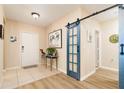 Bright entryway showcasing wood-look floors and a decorative barn door at 1748 Savannah Ln, Port Orange, FL 32128
