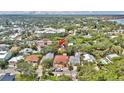 Aerial view of the home nestled among trees in a neighborhood near the water at 209 Esther St, New Smyrna Beach, FL 32169