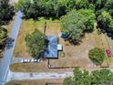 Expansive aerial view showing the house, large yard, and ample parking space of this property at 242 Cypress Ave, Oak Hill, FL 32759