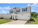 Charming two-story home featuring blue shutters, a manicured lawn, and a two-car garage at 2516 Hoptree Ln, Edgewater, FL 32141