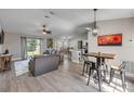 Bright open-concept living space with modern furnishings, sleek flooring, and a dining area with backyard views at 2713 Needle Palm Dr, Edgewater, FL 32141