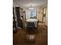 Cozy dining room featuring classic wooden furniture, a chandelier, and views of the outdoor area at 2725 Travelers Palm Dr, Edgewater, FL 32141