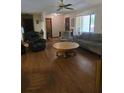 Inviting living room with hardwood floors, comfortable seating, and lots of natural light creating a warm ambiance at 2725 Travelers Palm Dr, Edgewater, FL 32141