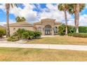 Beautiful home exterior with manicured lawn, palm trees, stone accents, and tile roof at 2913 Linari Ct, New Smyrna Beach, FL 32168