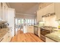 Bright kitchen features stainless appliances, granite countertops, wood floors, and an open layout at 2913 Linari Ct, New Smyrna Beach, FL 32168