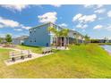 Spacious backyard next to a pond featuring a bench and professional landscaping in a well-maintained community at 3136 Portofino Blvd, New Smyrna Beach, FL 32168