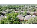Birds-eye-view of a community featuring beautiful two-story townhomes surrounded by mature trees and landscaping at 3311 Pine Oak Trl, Sanford, FL 32773