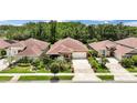 Aerial view of a well-maintained neighborhood showcasing single-Gathering homes and lush landscaping at 3376 Leonardo Ln, New Smyrna Beach, FL 32168