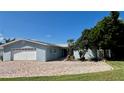 Exterior of home featuring a paver driveway and well manicured lawn at 34 Richmond Dr, New Smyrna Beach, FL 32169