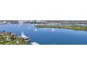 Water view featuring boats and lush vegetation on a sunny day at 34 Richmond Dr, New Smyrna Beach, FL 32169