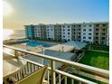 Resort featuring a pool, manicured lawn, and stunning ocean view from the balcony at 4151 S Atlantic Ave # 414, New Smyrna Beach, FL 32169