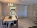 Cozy dining area featuring a table with seating for four and an elegant light fixture at 4175 S Atlantic Ave # 5280, New Smyrna Beach, FL 32169