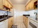 Efficient kitchen featuring light wood cabinets and black countertops at 4225 S Atlantic Ave # 218, New Smyrna Beach, FL 32169