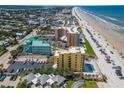 Gorgeous aerial view of beachfront condos, coastline and cityscape with ocean and white sandy beach at 425 S Atlantic Ave # 302, New Smyrna Beach, FL 32169