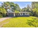 Charming single-story home with a well-maintained lawn and mature landscaping at 431 Palmetto St, Edgewater, FL 32132