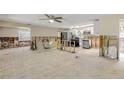 Spacious living room ready for renovation with ample natural light and ceiling fan at 431 Palmetto St, Edgewater, FL 32132