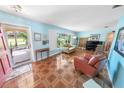 Inviting living room featuring tiled floors, large windows, comfortable seating, and natural light at 4350 Candlewood Ln, Ponce Inlet, FL 32127