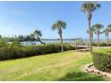 Beautiful backyard features lush green grass, pretty landscaping and water views at 460 Bouchelle Dr # 104, New Smyrna Beach, FL 32169