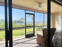 Relaxing screened porch with comfortable seating and scenic waterfront views at 460 Bouchelle Dr # 104, New Smyrna Beach, FL 32169