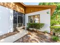 Inviting home exterior showcasing a screened door and a well-manicured garden at 5 Soco Trl, Ormond Beach, FL 32174